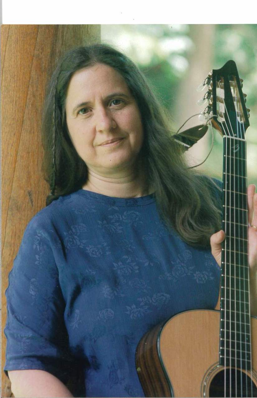 Betsy Wellings, wearing a guitar.