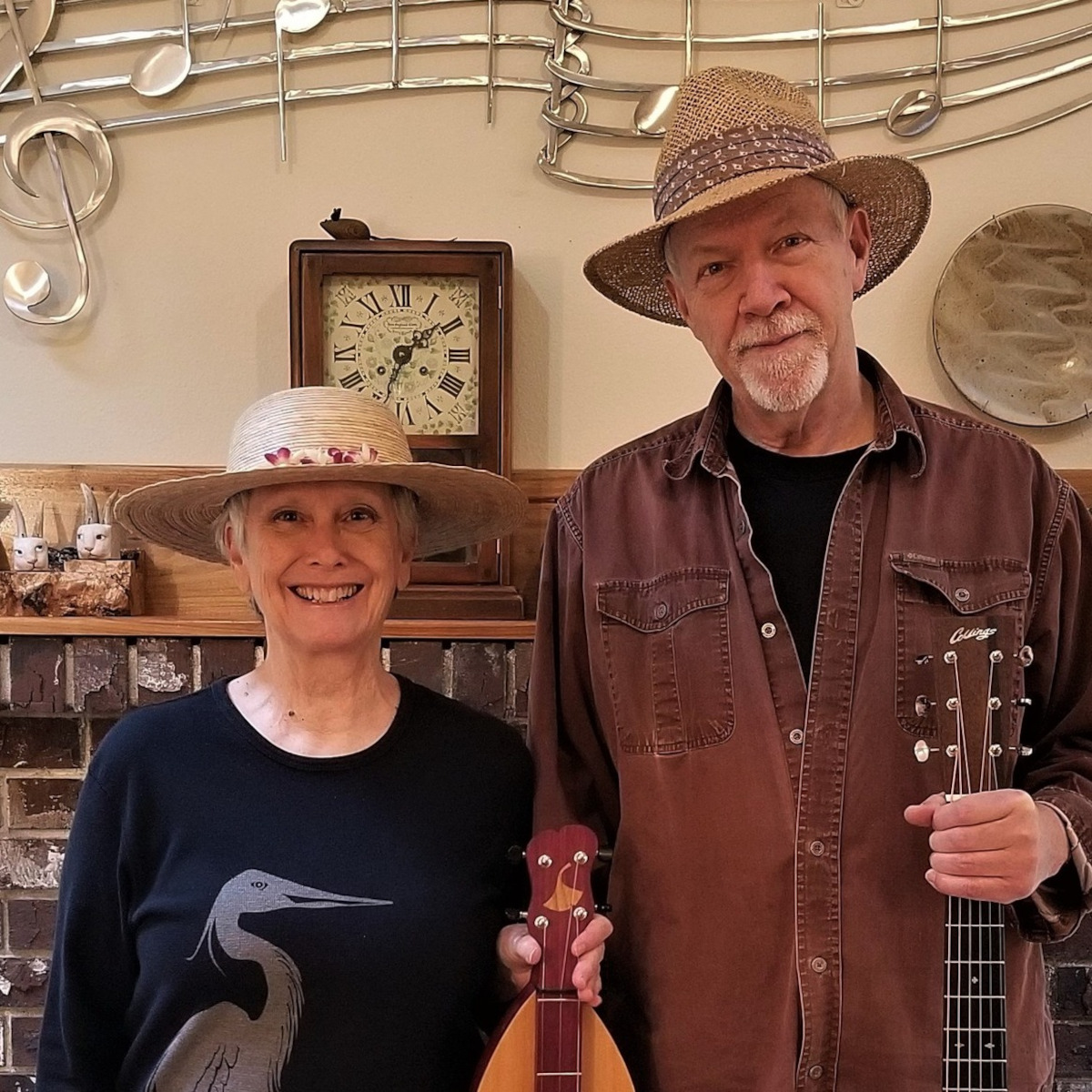 Hank and Claire, holding instruments.