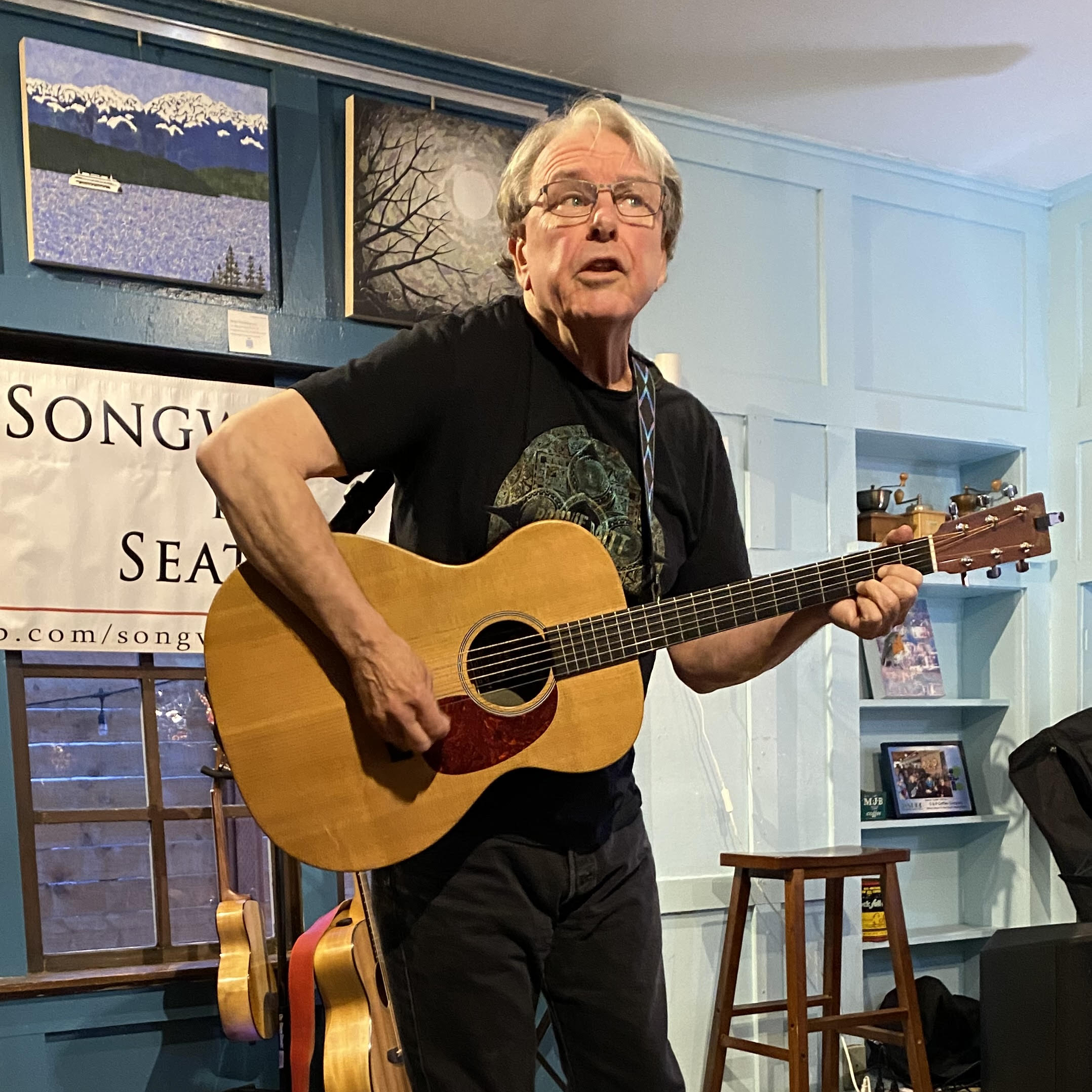 Karl Robert Neice performing with a guitar.