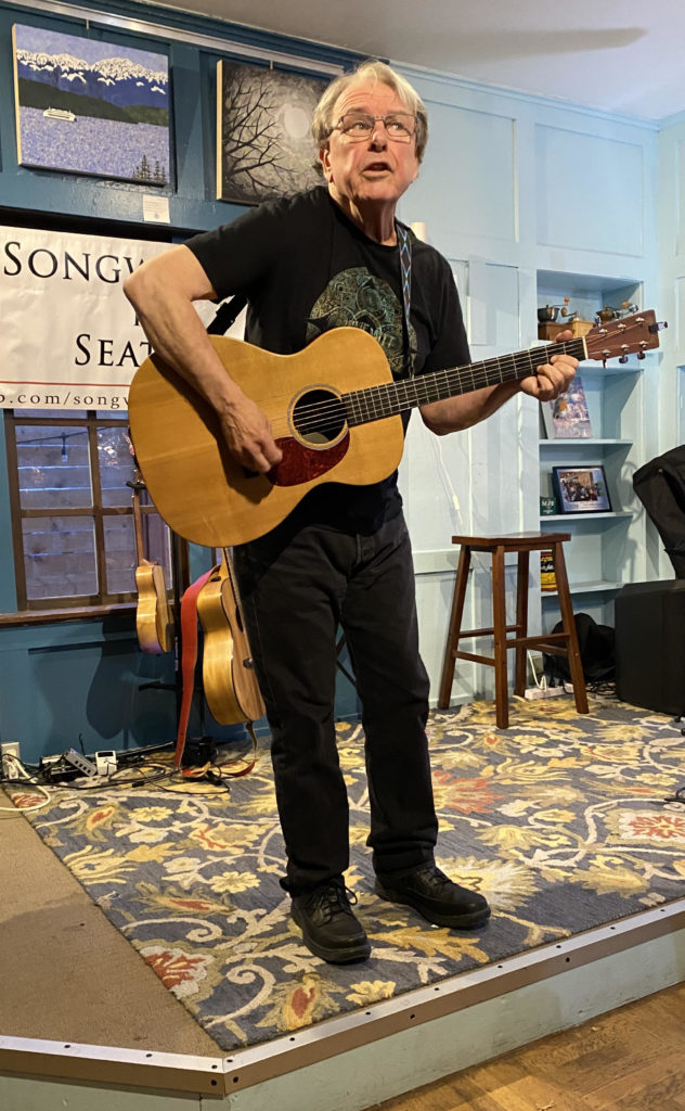 Karl Robert Neice, playing a guitar.