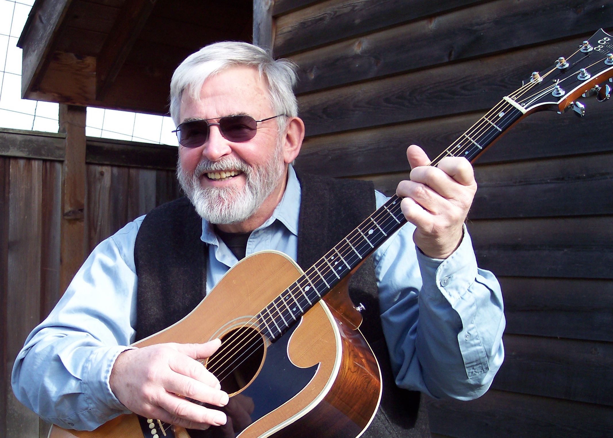 Mike Murray playing a guitar.