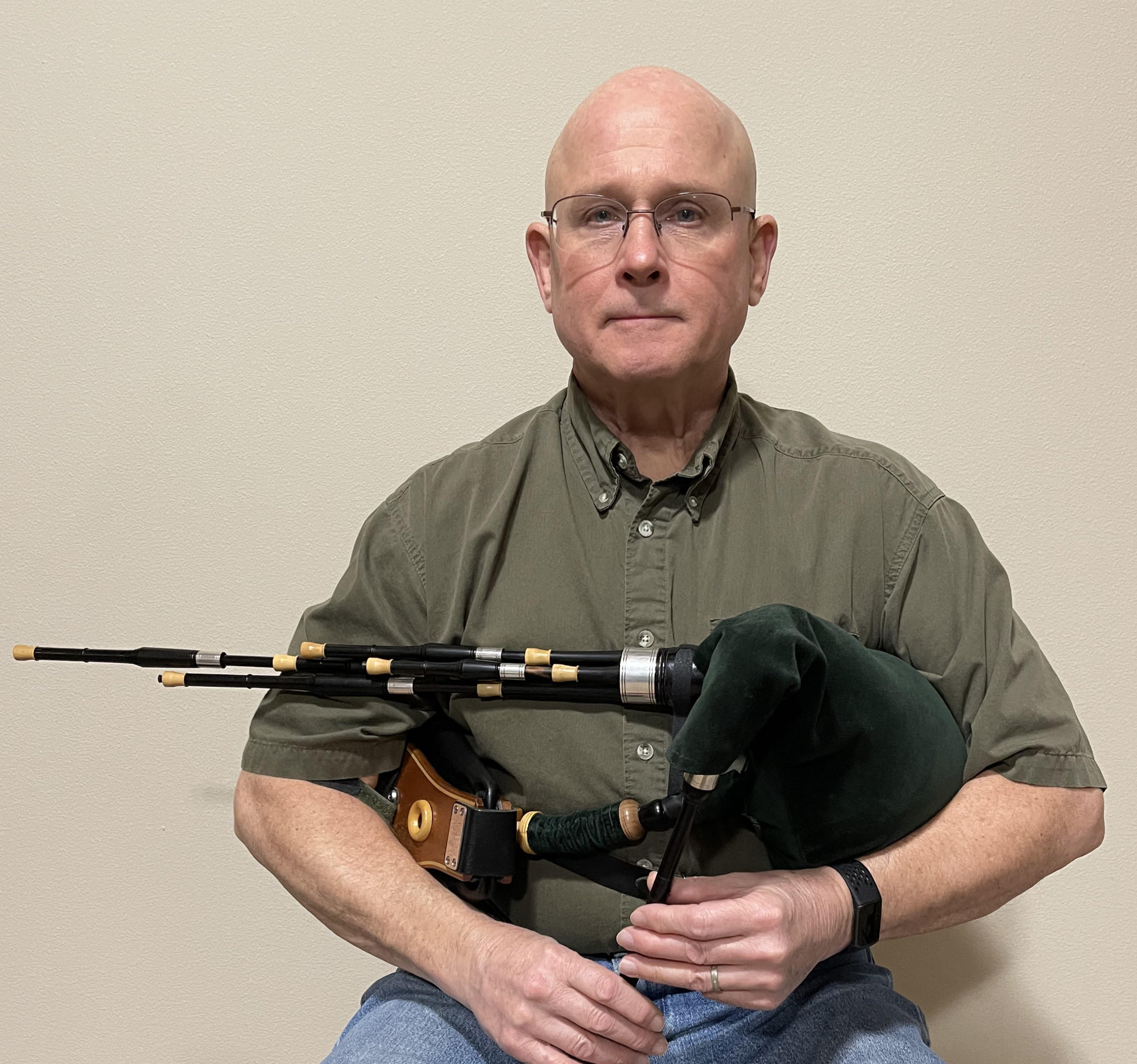 David Lanigan, Skweez the Weezle, holding smallpipes.