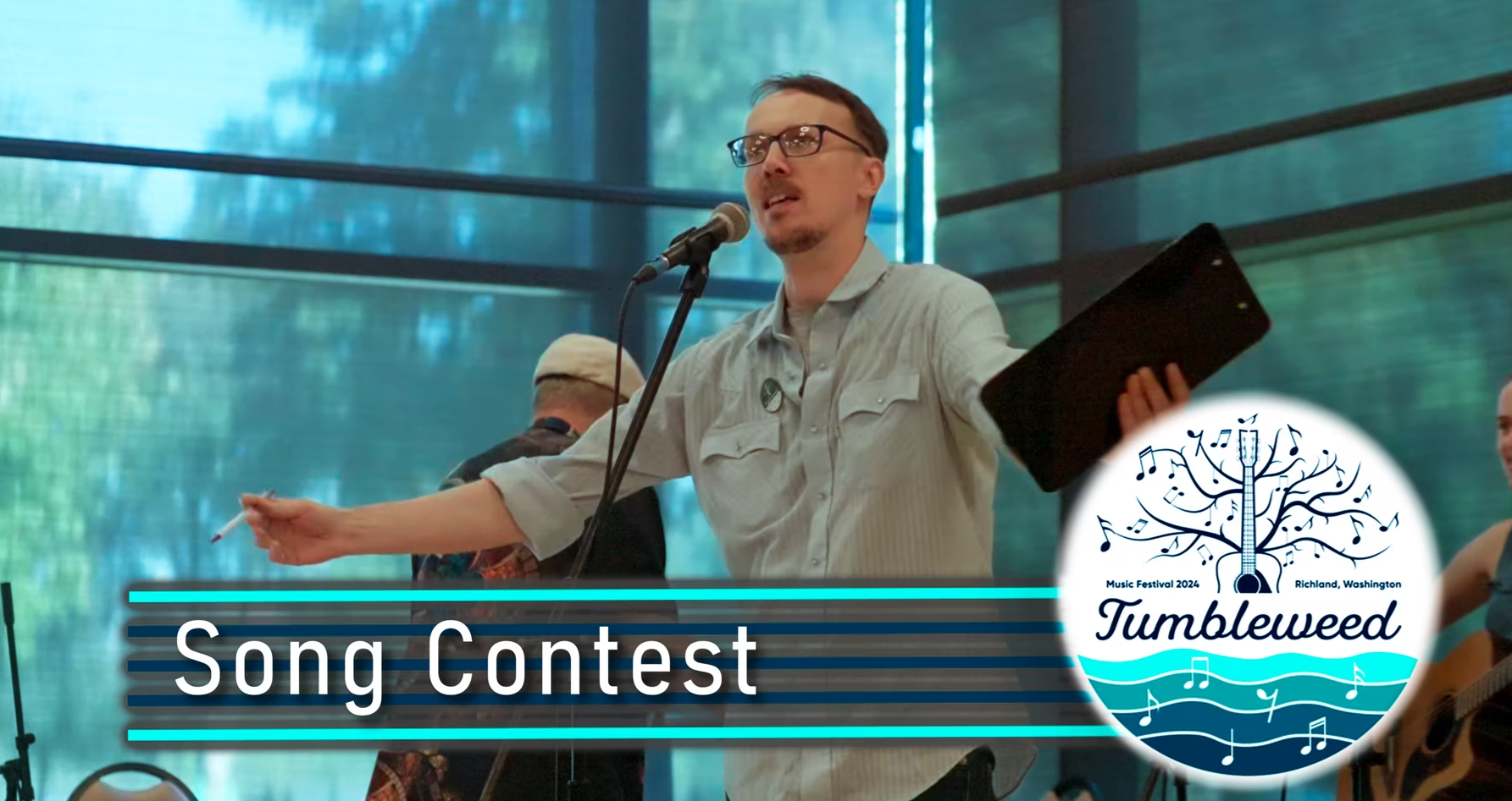 Wes Weddell MC'ing the 2024 Jane Titland memorial SOngwriting Contest Finalists' performances in the Community Center Stage.